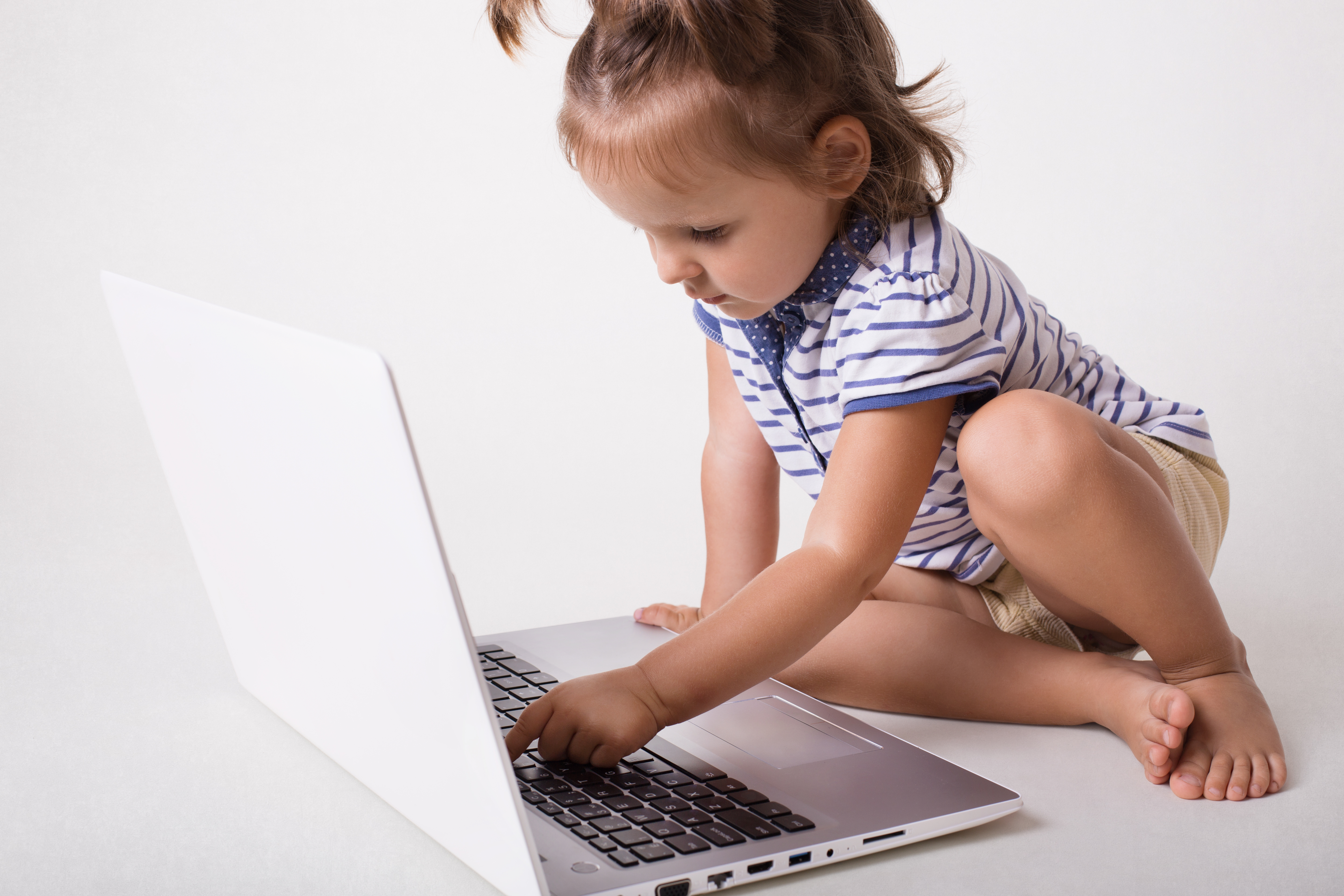 little-small-female-kid-sits-front-opened-laptop.jpg