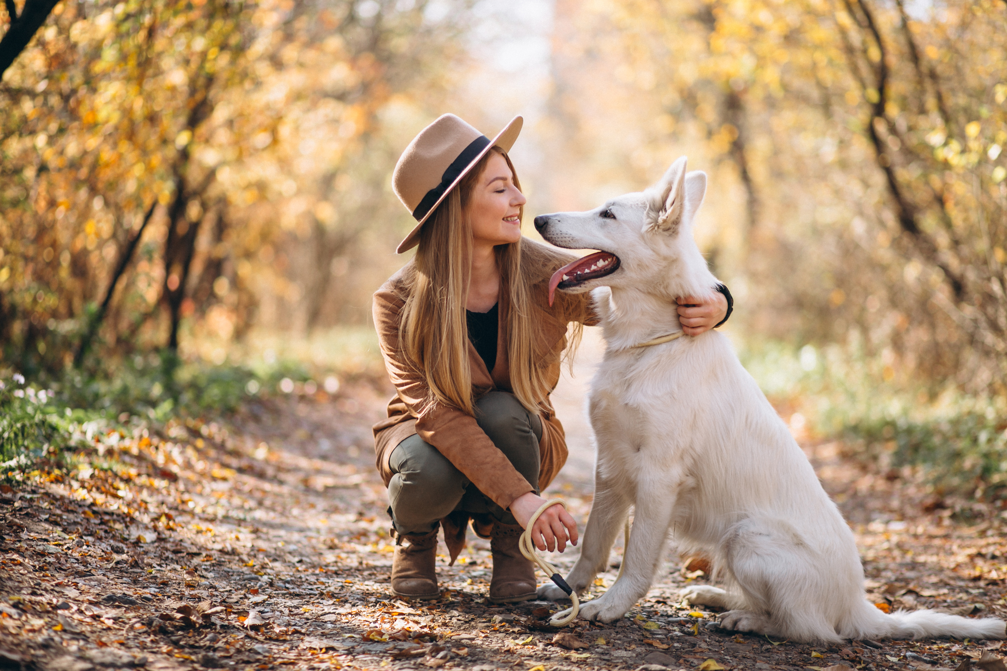 young-woman-park-with-her-white-dog.jpg